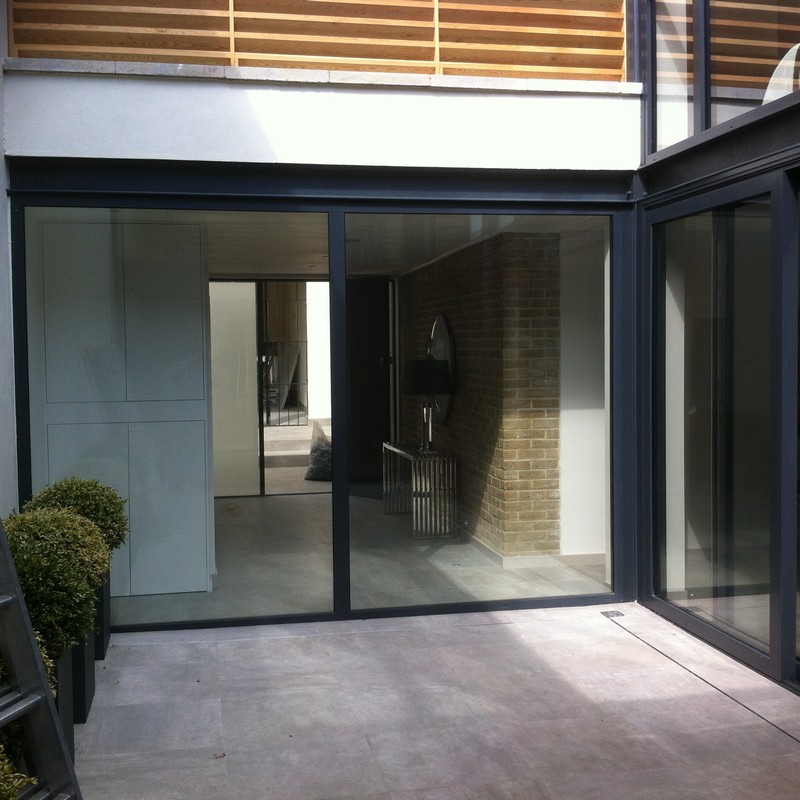 Floor-to-ceiling sliding doors opening to courtyard in South Kensington