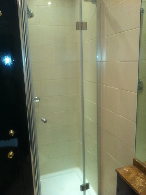 Frameless glass shower enclosure with chrome fittings in South Kensington