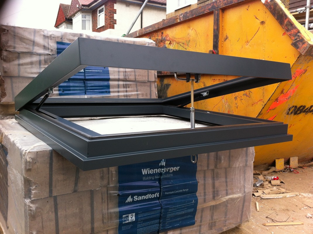 Opening flat roof skylight in anthracite grey installed in South Kensington