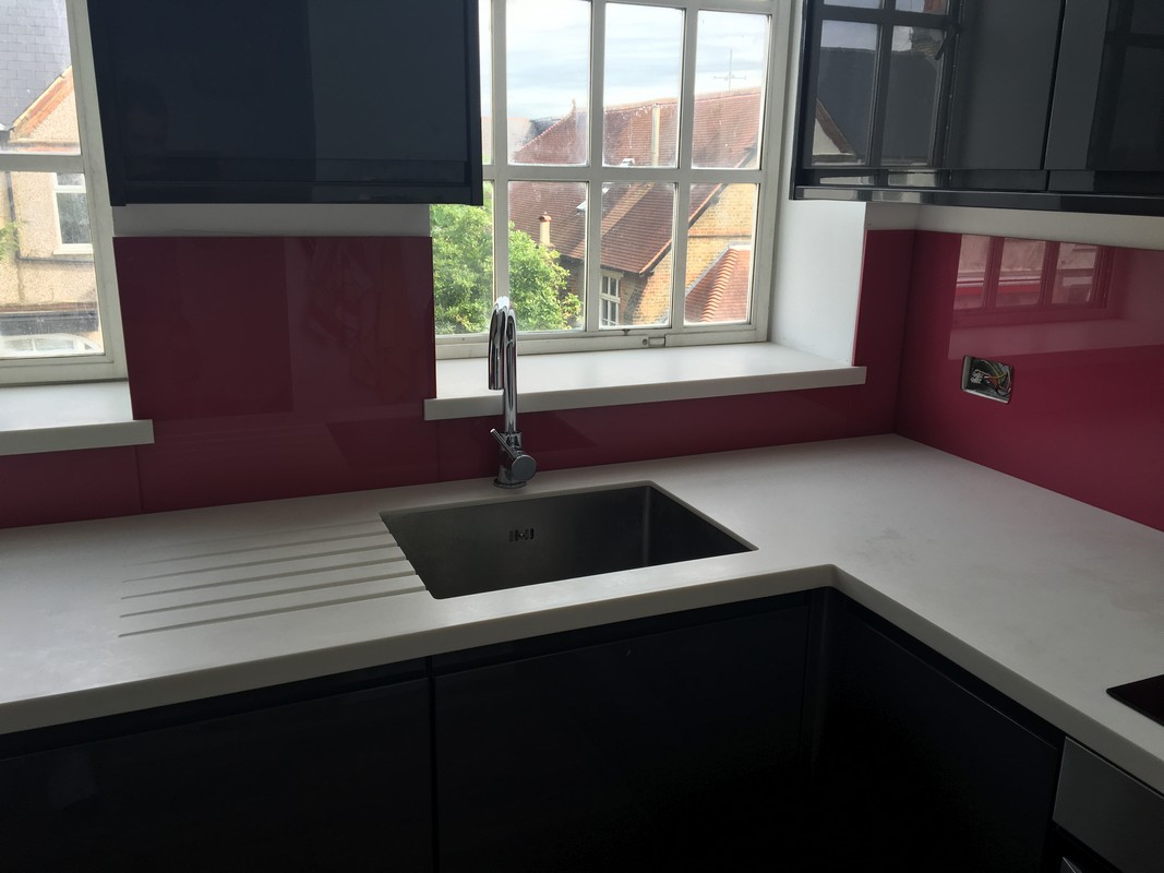 Deep plum coloured glass splashback in modern South Kensington kitchen